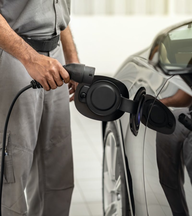 closeup-asian-technician-hand-is-charging-the-electric-car-or-ev-in-service-center.jpg